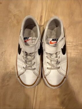 Nike Kids White Sneakers with Black Swoosh and Orange Accent